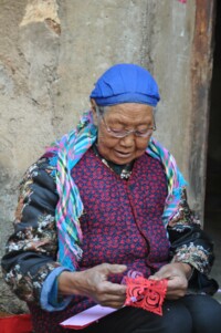 Chinese elderly woman using glasses
